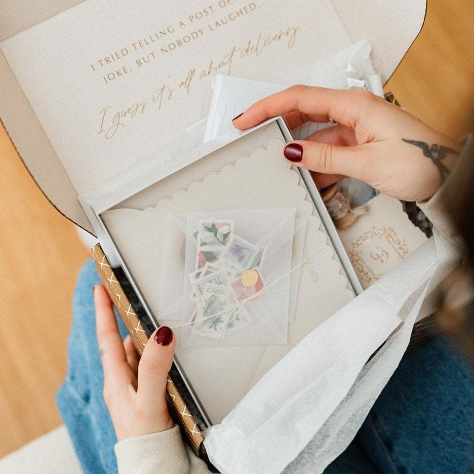 a person holding a stationery subscription box